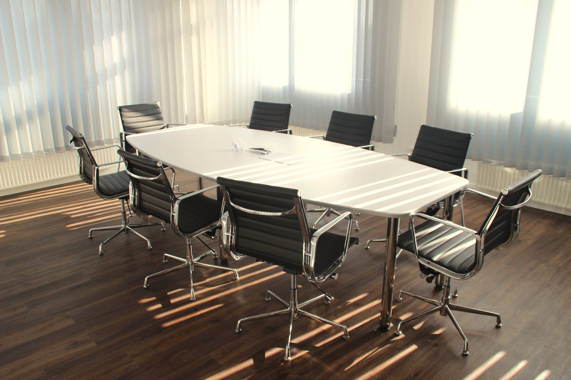 Sunlit meeting room with an empty conference table