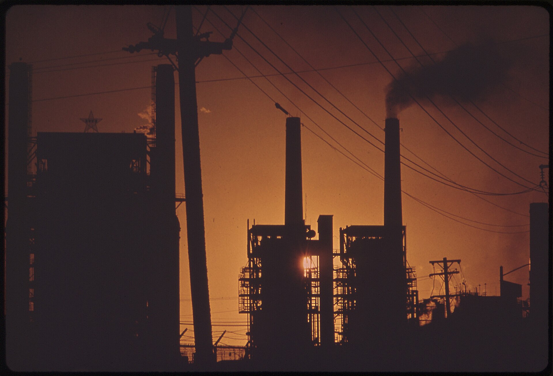 A refinery at sunset, the kind of plant whose equipment arrives through RFQs and technical tenders